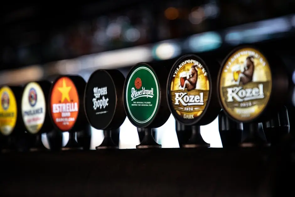 Close-up view of beer taps in a bar featuring diverse brand logos and labels.