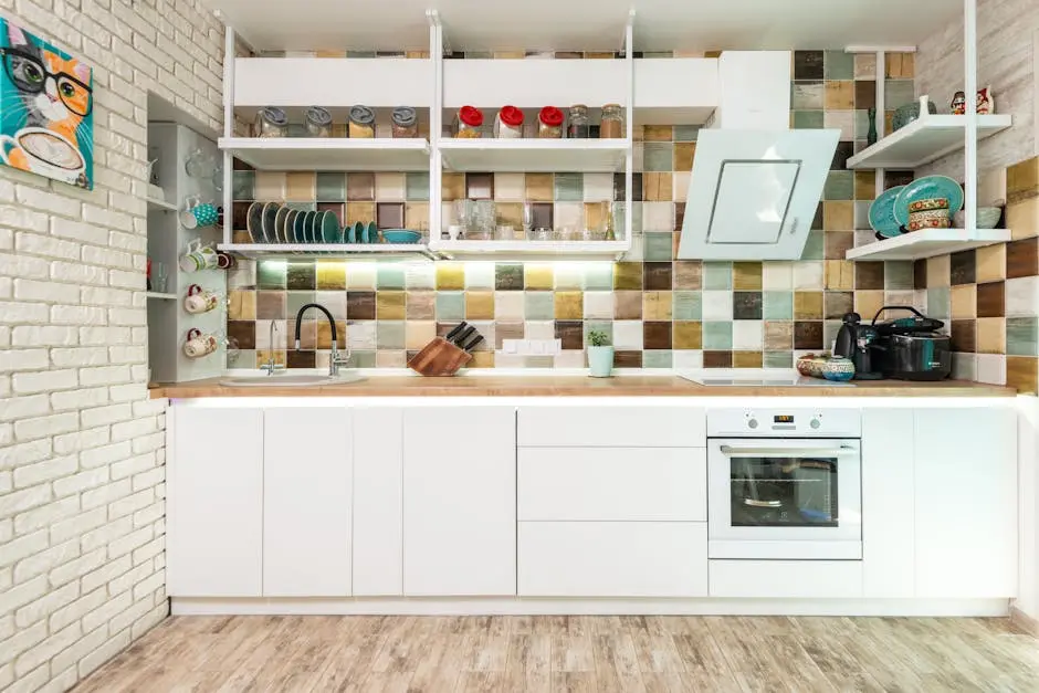 Bright modern kitchen featuring colorful tiles and sleek white cabinetry.