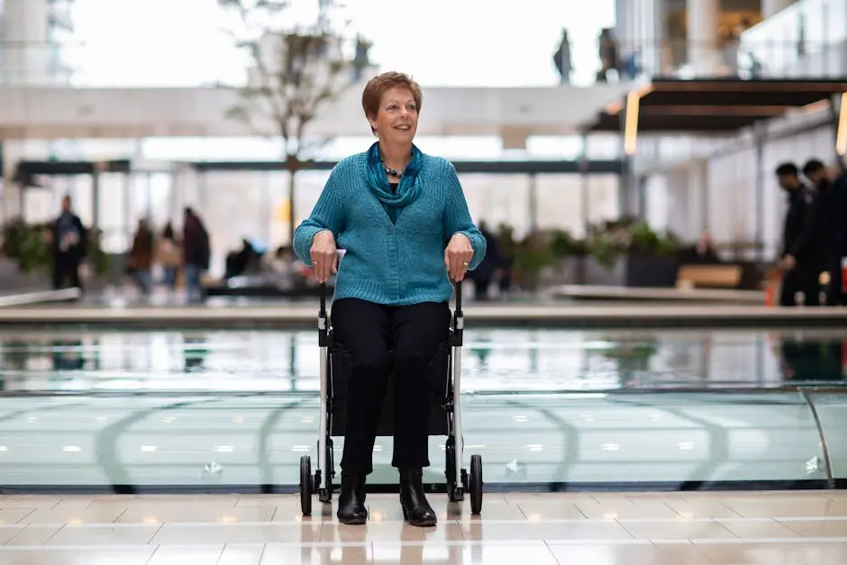 Senior woman smiling in a wheelchair inside a modern building in Utrecht, Netherlands