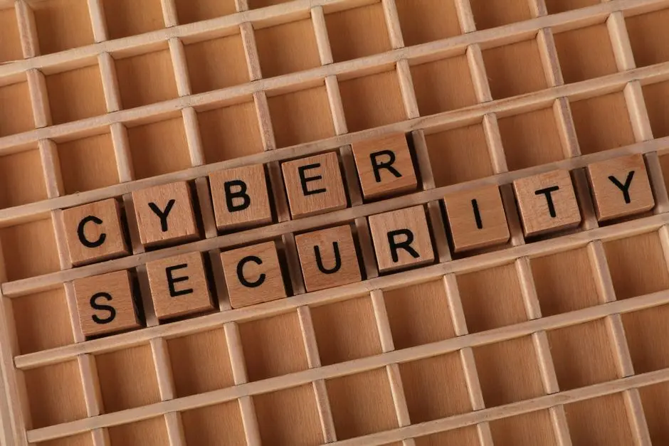Wooden blocks spelling ‘Cyber Security’ on a wooden grid background.