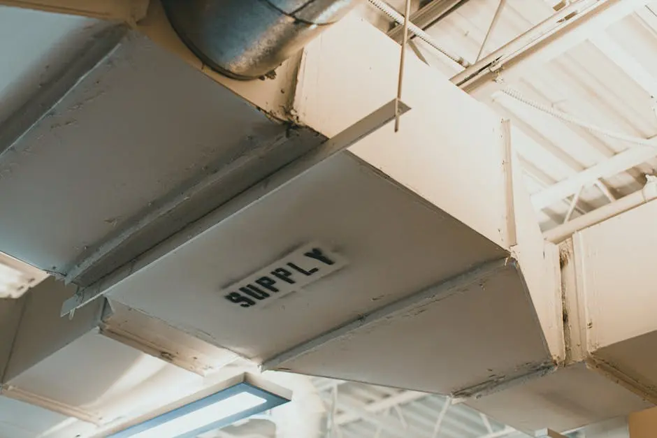 Close-up view of an air duct labeled &lsquo;SUPPLY&rsquo; in an industrial setting.