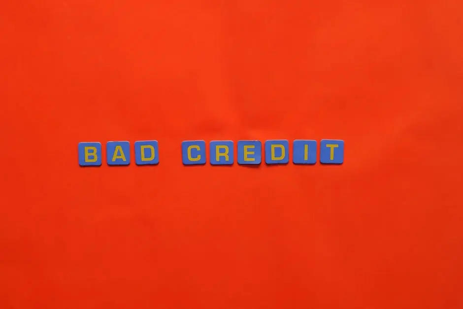 Blue letter blocks spelling &lsquo;Bad Credit&rsquo; on an orange background.