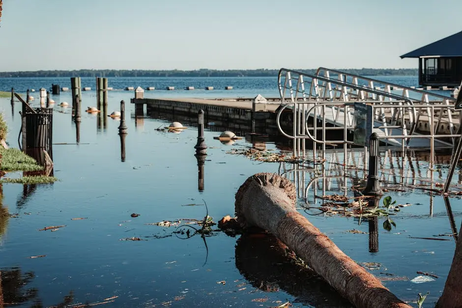A scenic view of a flooded pier with debris and calm waters.