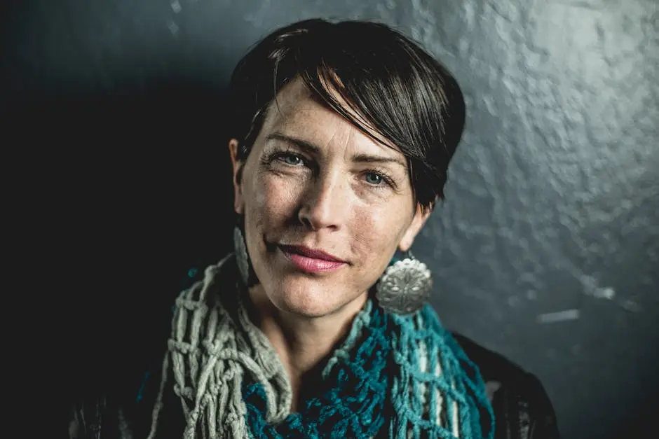 Close-up portrait of a stylish woman with short hair and bold earrings, exuding confidence.