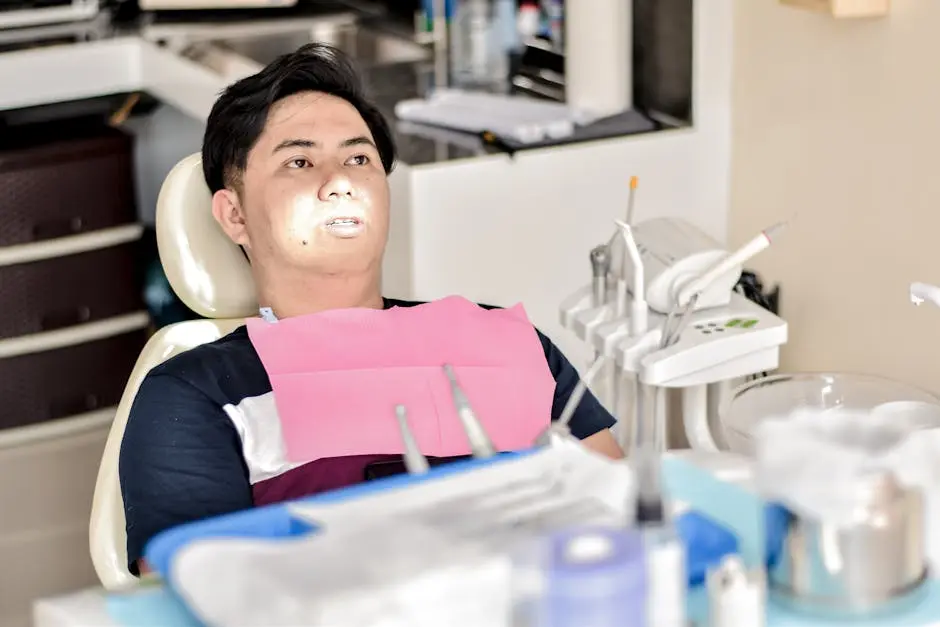 A patient sitting in a dental chair, prepared for a dental examination in a modern clinic.