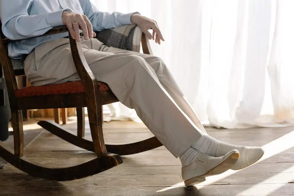 Senior adult sitting comfortably in a rocking chair by a window, exuding relaxation and warmth indoors.