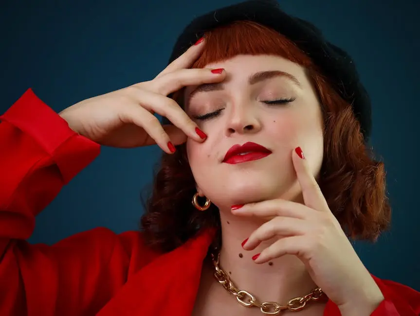 Close-up portrait of a fashionable woman in red attire, with red nails and accessories.