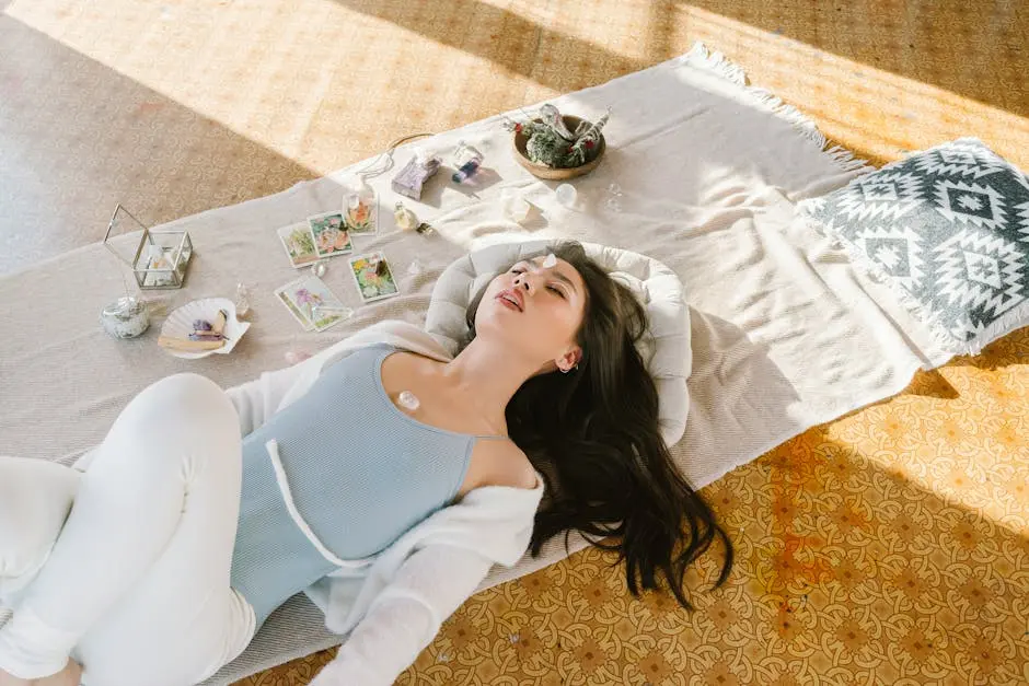 A young woman meditates peacefully with crystals and tarot cards, promoting wellness and mindfulness.