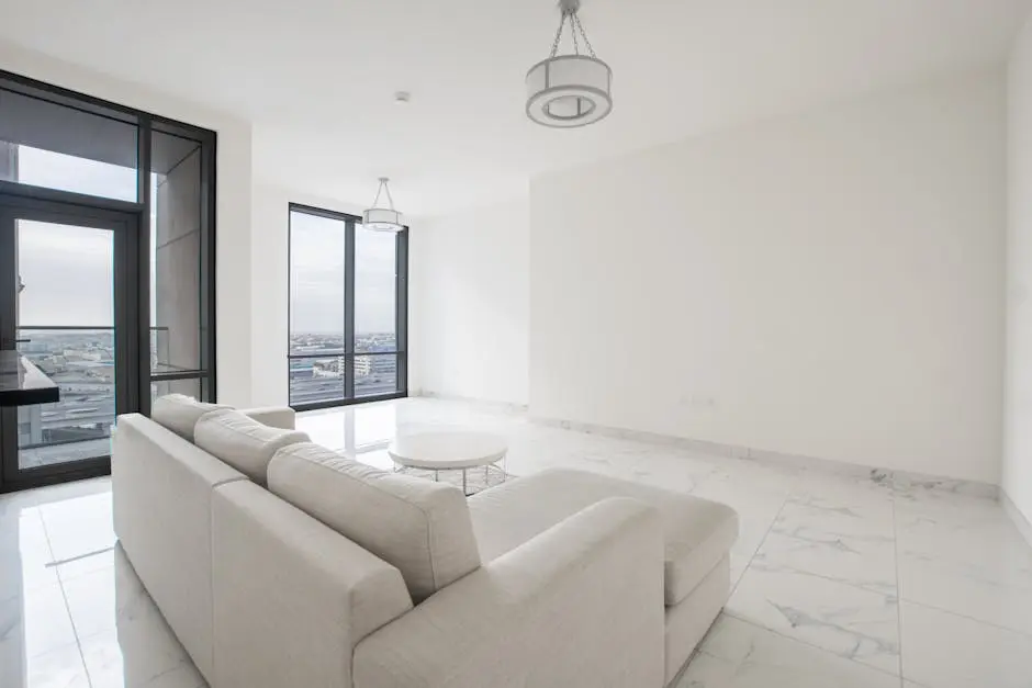 Spacious and bright minimalist living room with a city view, featuring large windows and a contemporary design.