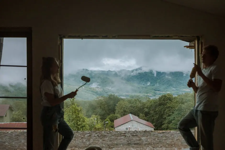 Couple painting and enjoying a scenic mountain view from their home renovation.