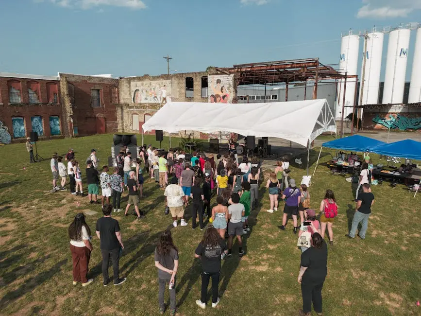 A vibrant outdoor concert in Chattanooga with a crowd enjoying live music under sunny skies.