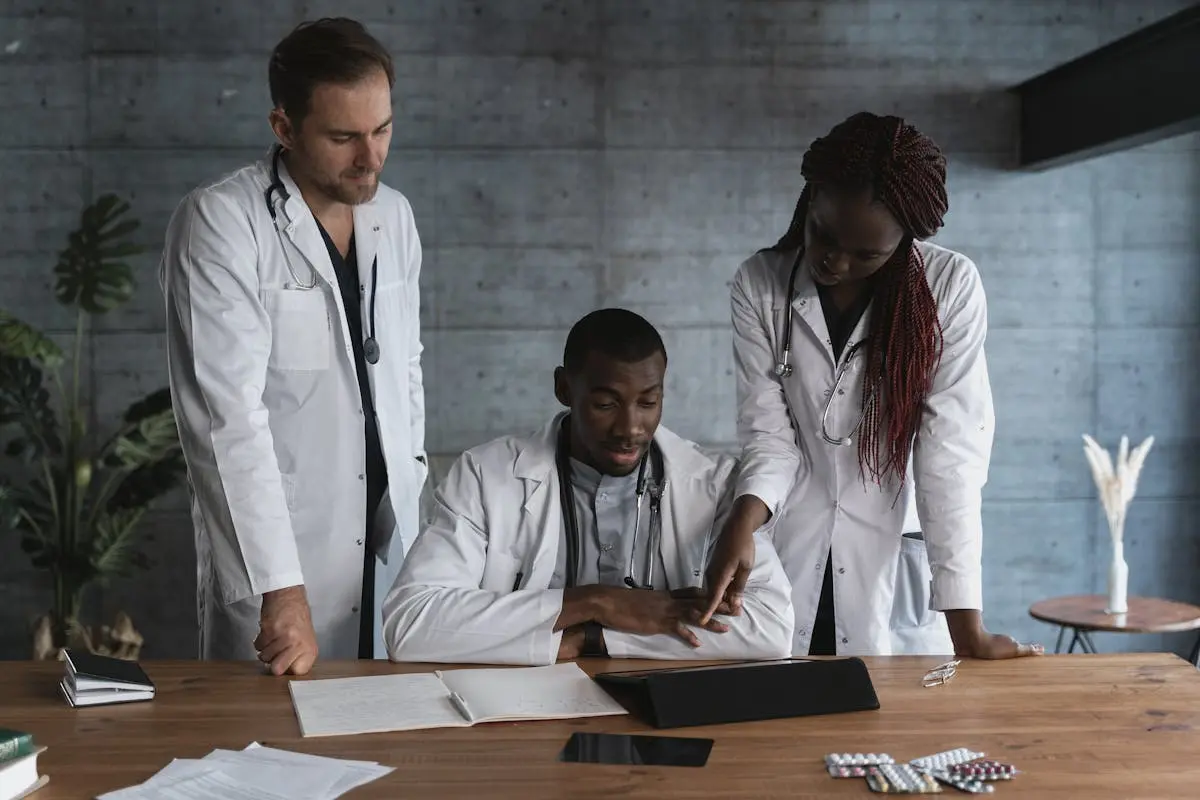 Doctors in discussion at a medical clinic, working on patient treatment plans.