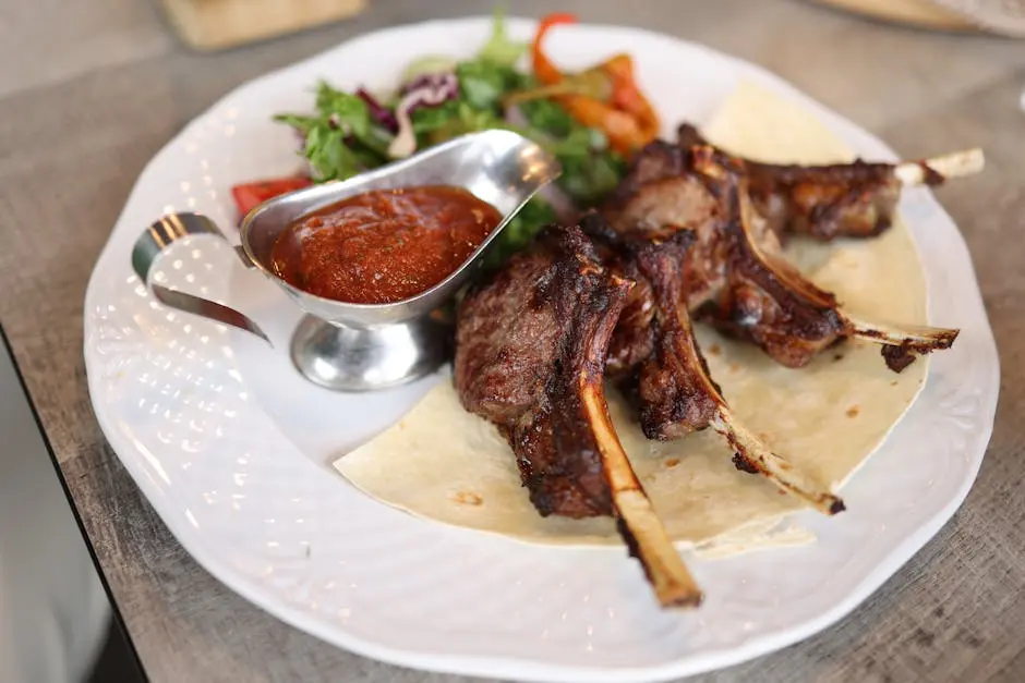 Savor these succulent grilled lamb chops served with rich sauce and fresh salad.
