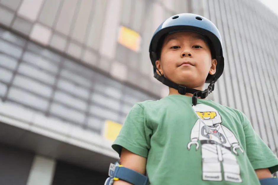 Confident child with helmet poses outdoors in the city, showcasing safety and playfulness.