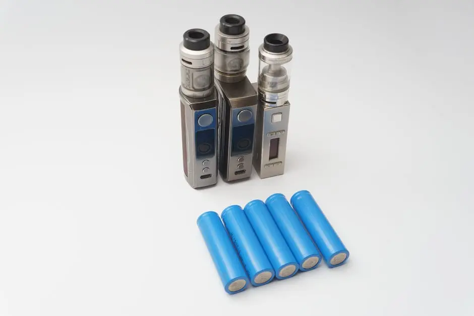 Three vape mods and six blue 18650 batteries on a white surface.