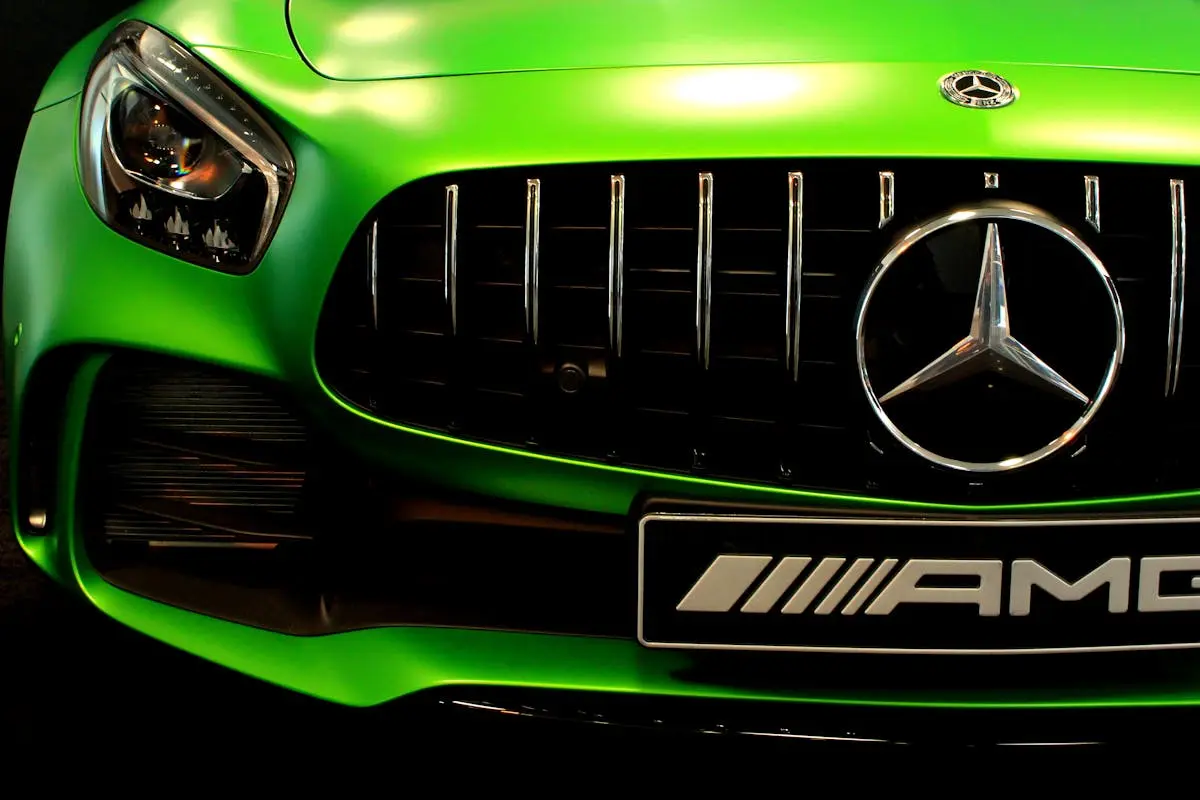 Close-up of a vibrant green Mercedes AMG grille showcasing the sleek design.