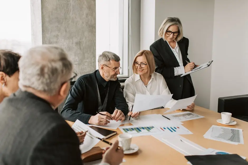 A diverse group of business professionals engaged in a strategic meeting, team leadership.