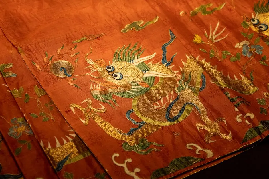 Close-up of an ornate dragon embroidery on red silk fabric showcasing traditional art.
