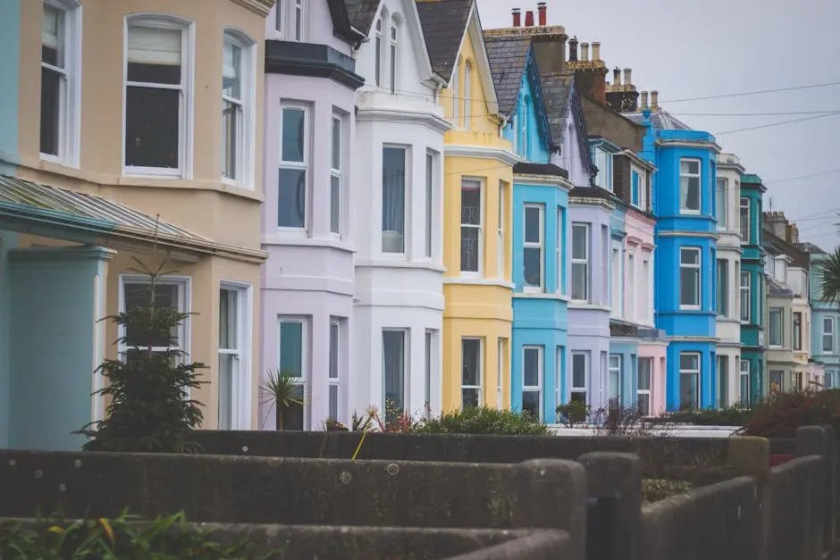 Vibrant row of Victorian-style houses with colorful facades in a residential neighborhood.