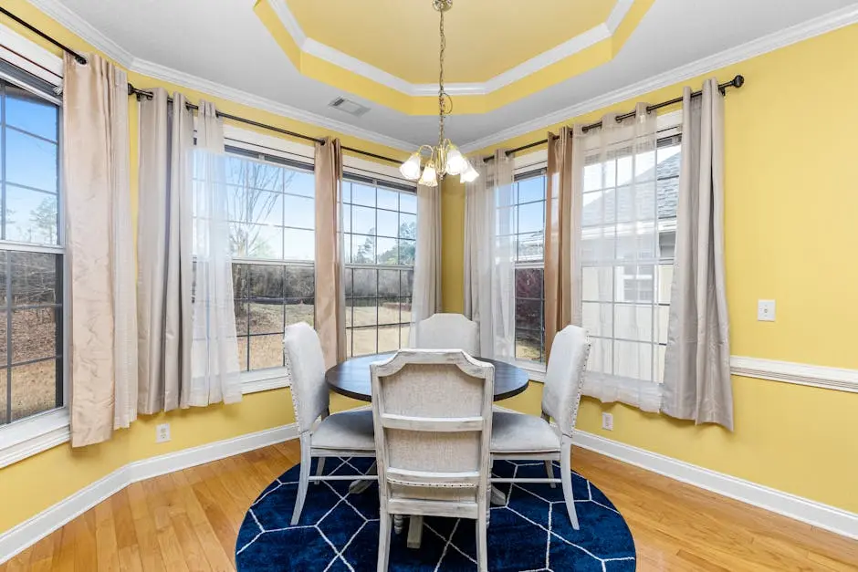 Cozy dining room with elegant decor, natural light, and stylish furnishings.