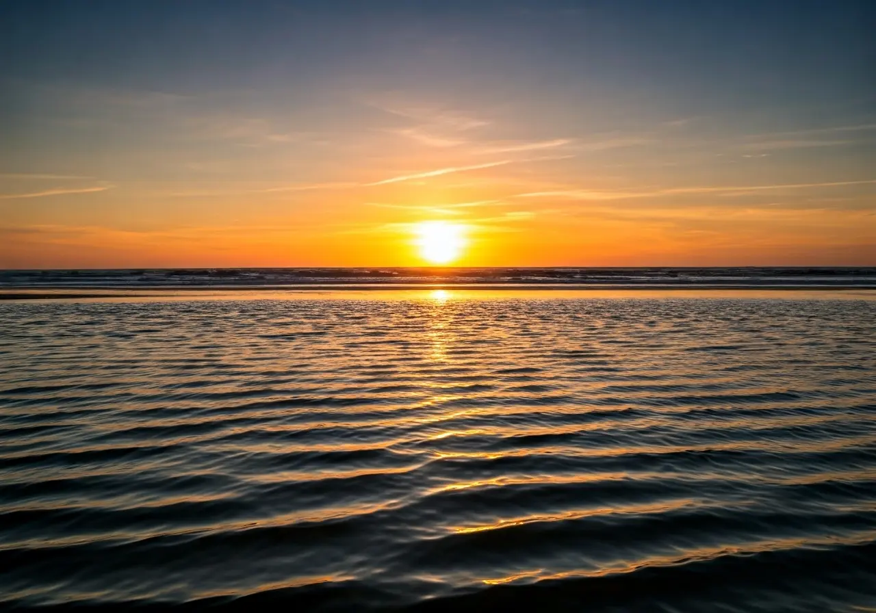 A serene beach sunset illustrating calm and relaxation. 35mm stock photo