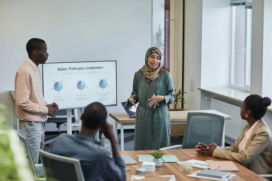 A diverse group of professionals in a business meeting discussing sales strategies.