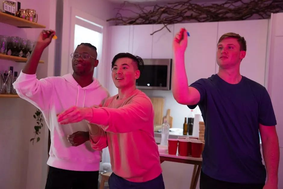 Three friends enjoying a fun darts game at home with vibrant pink lighting.