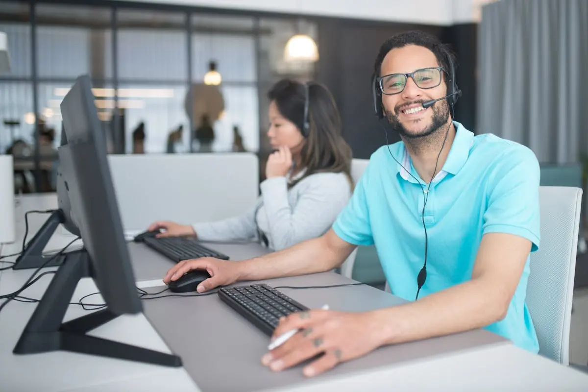 Professional call center agents providing customer service at an office workspace.