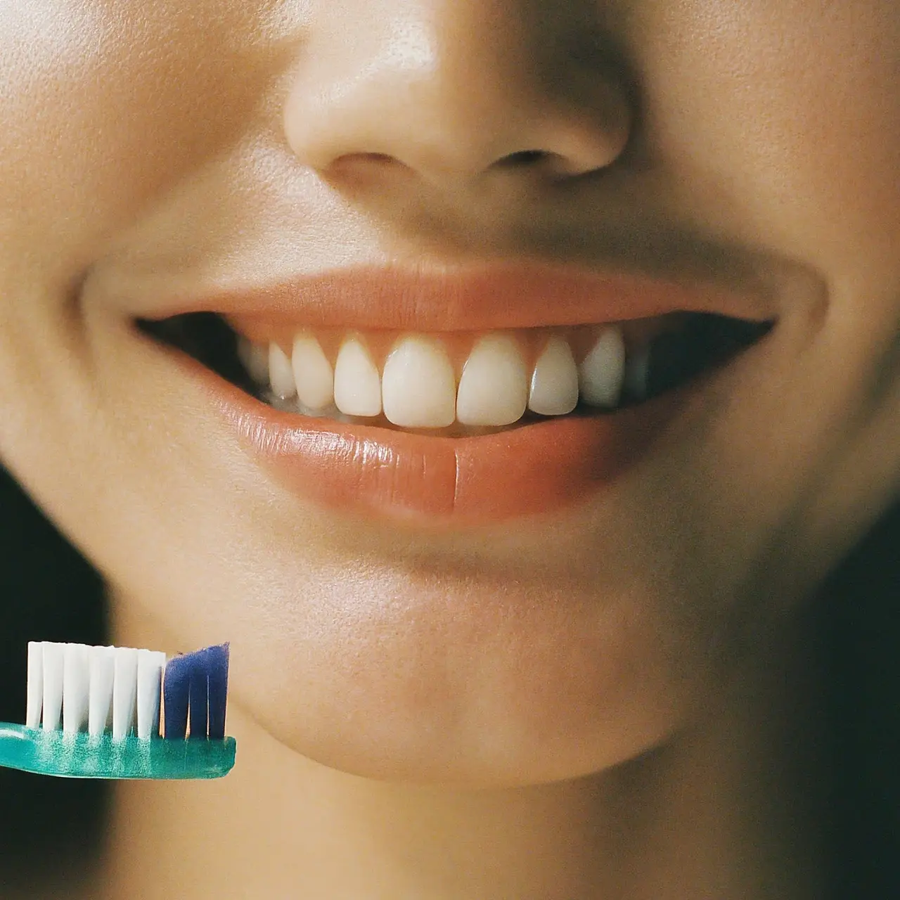Close-up of a healthy smile with a toothbrush nearby. 35mm stock photo
