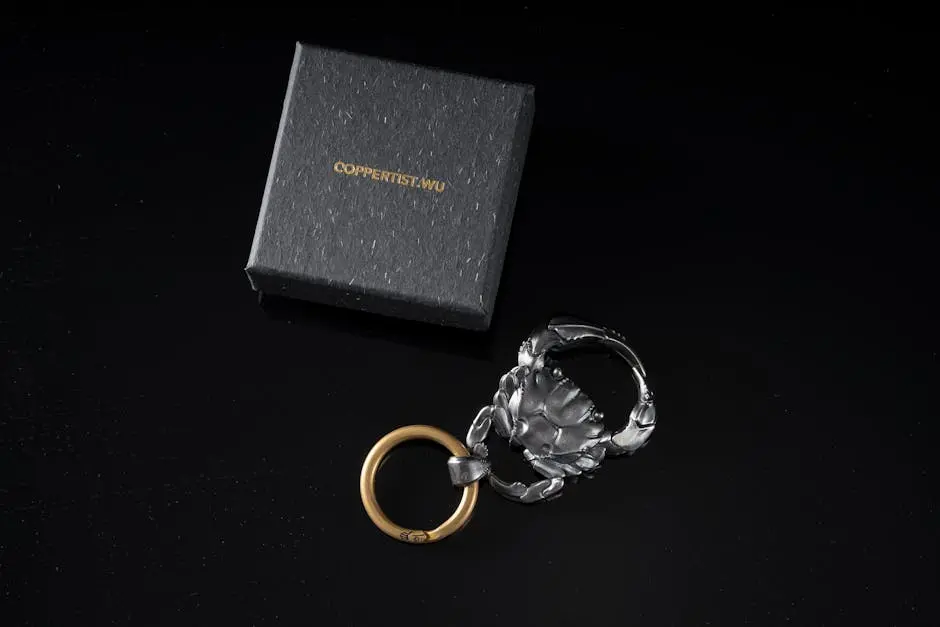 Stylish silver crab keychain on a dark background, presented with a gift box.