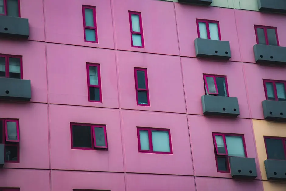 Close-up of a modern pink building facade with colorful windows in Melbourne, Australia.