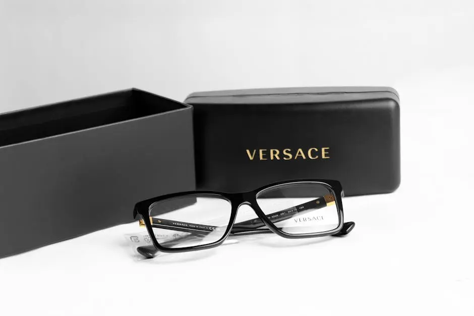 Stylish Versace eyeglasses with a black frame and elegant case shown in a minimalistic flat lay.