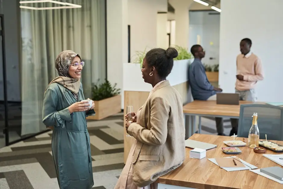 Diverse group of professionals interacting in a modern office setting.