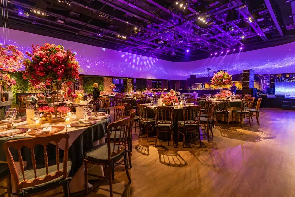 Lavishly decorated event hall with elegant tables and purple lighting, ideal for celebrations.