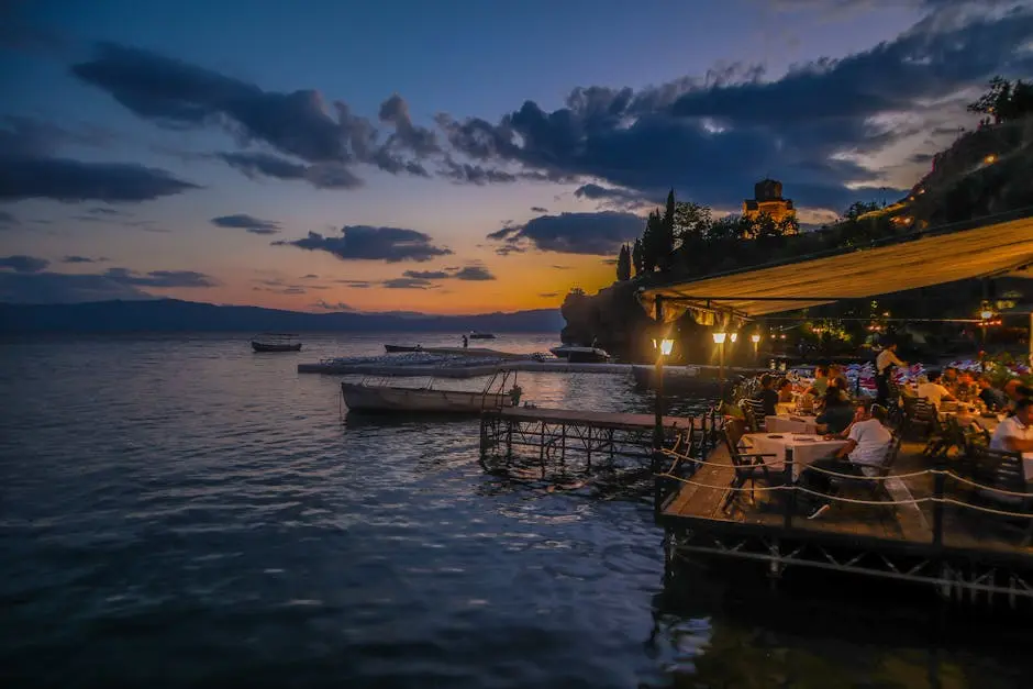 Serene evening view of a lakeside restaurant at sunset in Ohrid, Macedonia.