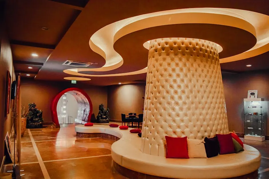 Luxurious indoor setting featuring a modern circular seating area with artistic ceiling design.