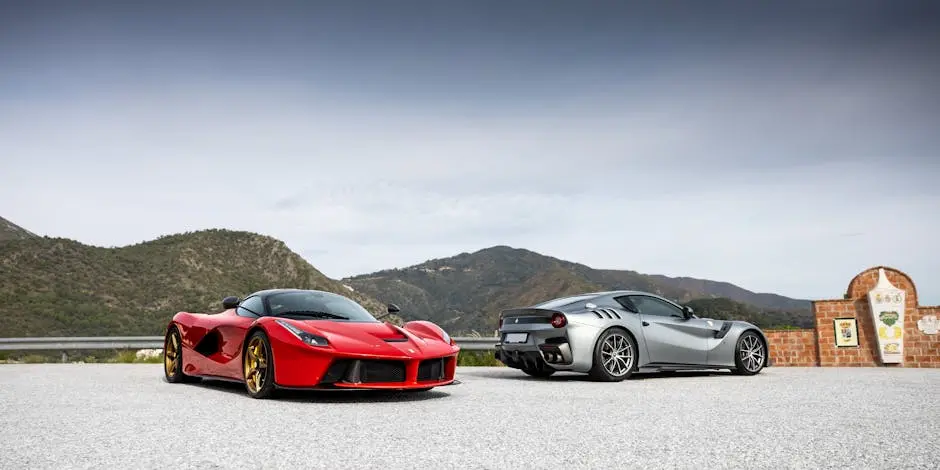 Two luxury sports cars parked with a scenic mountain backdrop. Perfect for automotive enthusiasts.