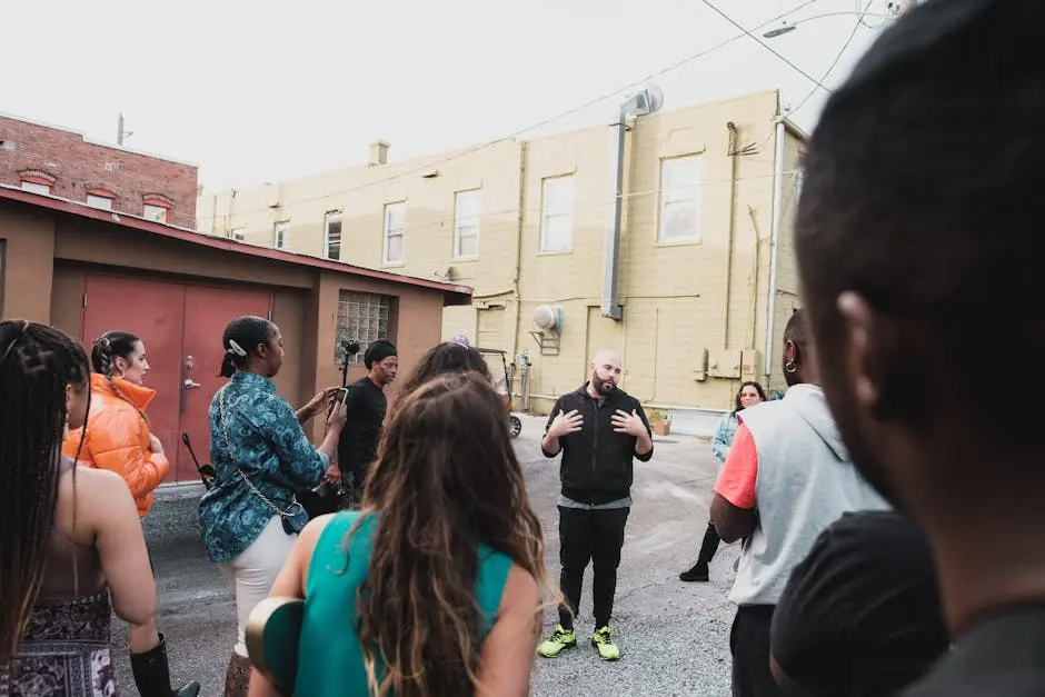 A diverse group of adults engaging in a community meeting on an urban Sanford street.