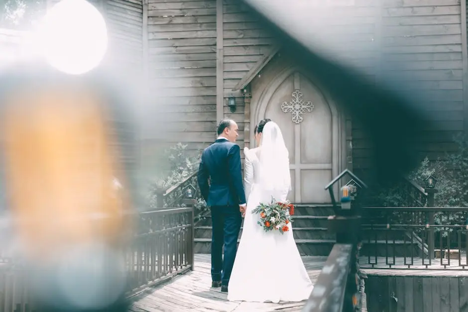 Bride and groom holding hands at a quaint wooden chapel wedding.