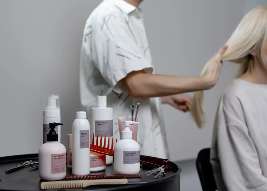 A hairdresser styling a blonde woman’s hair in a salon, showcasing hair care products on a table.