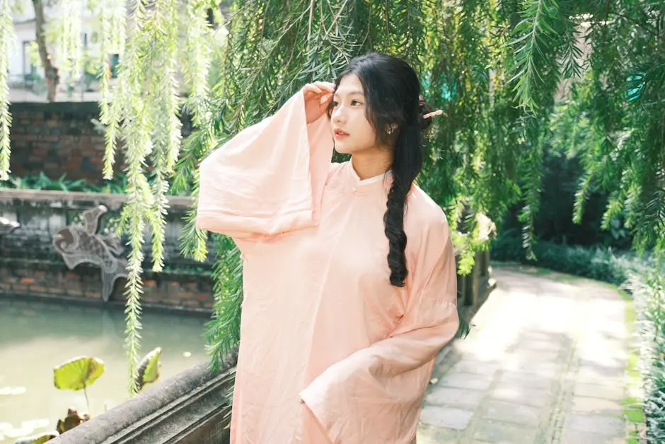 Young woman in traditional clothing standing among lush greenery