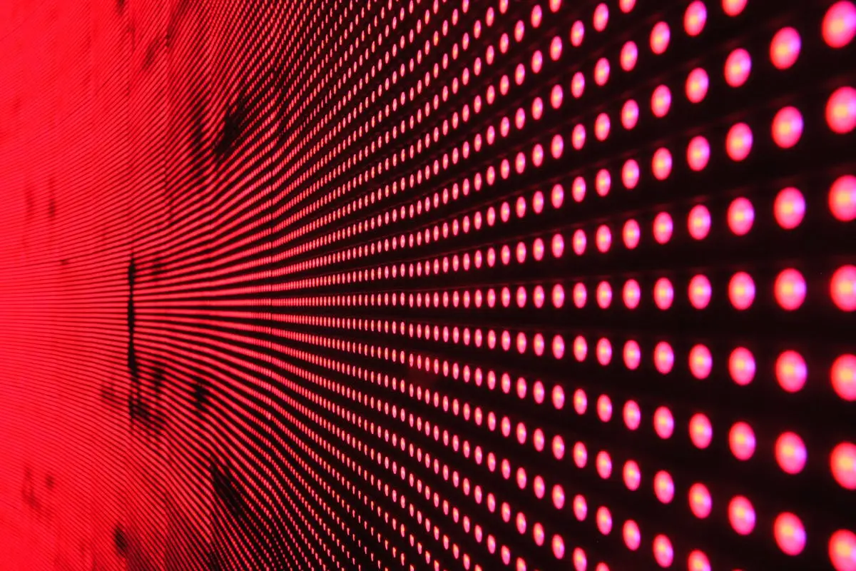 Vibrant abstract pattern of illuminated red LED lights forming a dynamic design. IT Modernization
