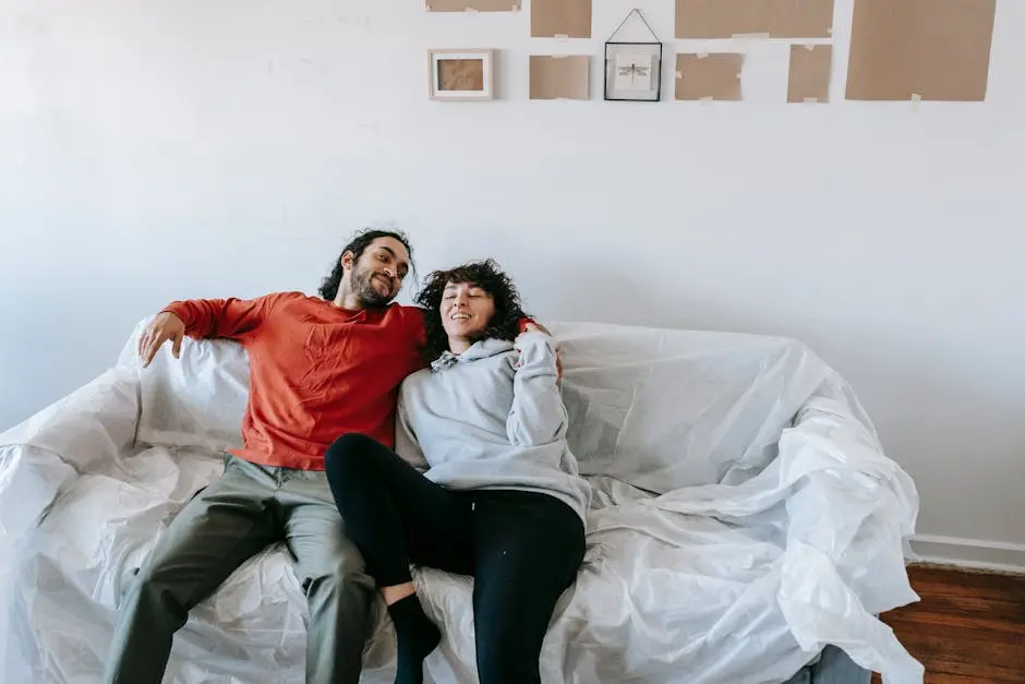 A happy couple enjoying a relaxed moment on a sofa in their home, symbolizing comfort and togetherness.
