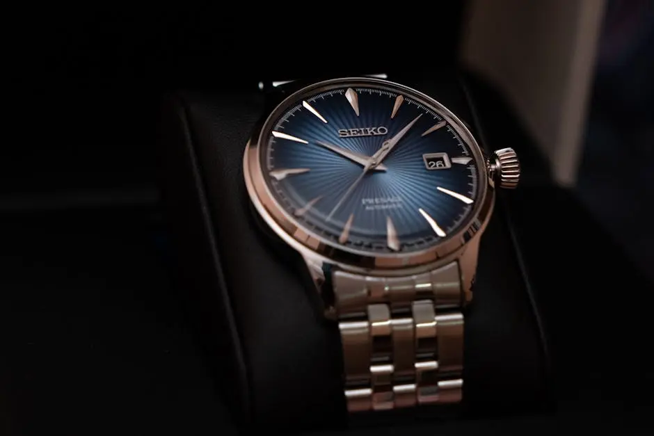 Elegant Seiko wristwatch with a blue dial and silver band on a black cushion.