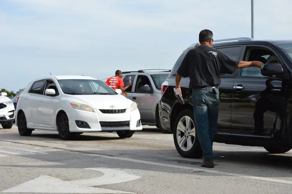 Traffic officer directing vehicles on a busy road intersection during daytime.