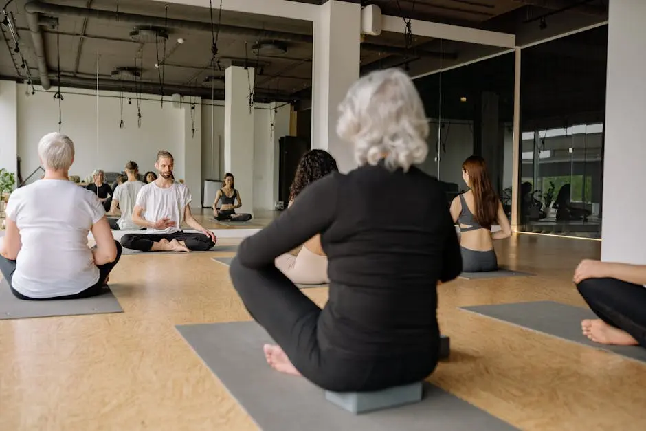A diverse group practicing yoga in a modern, serene studio space promoting wellness.