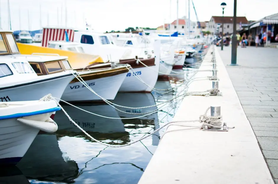 A collection of boats moored at a harbor pier on a clear day. Perfect for travel and maritime themes.