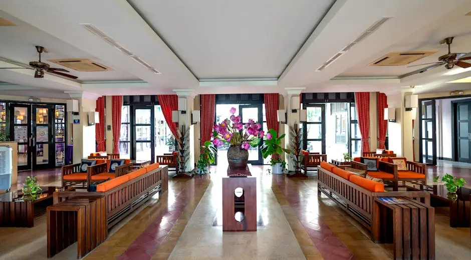 Luxurious hotel lobby showcasing elegant furniture and vibrant floral arrangements.