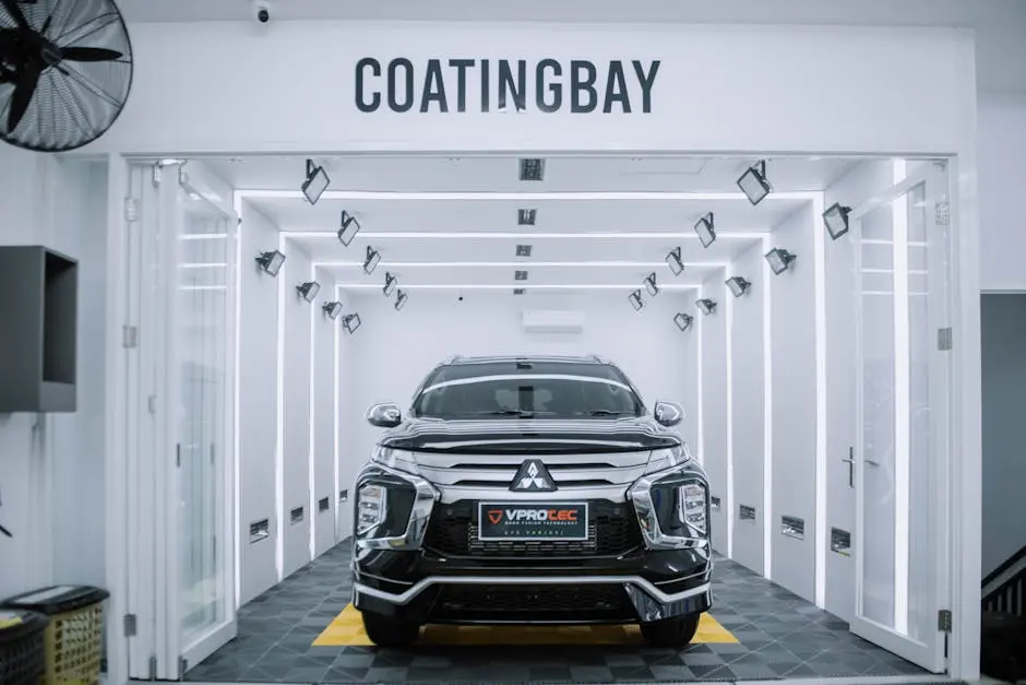 A sleek Mitsubishi SUV inside a modern automotive coating facility.