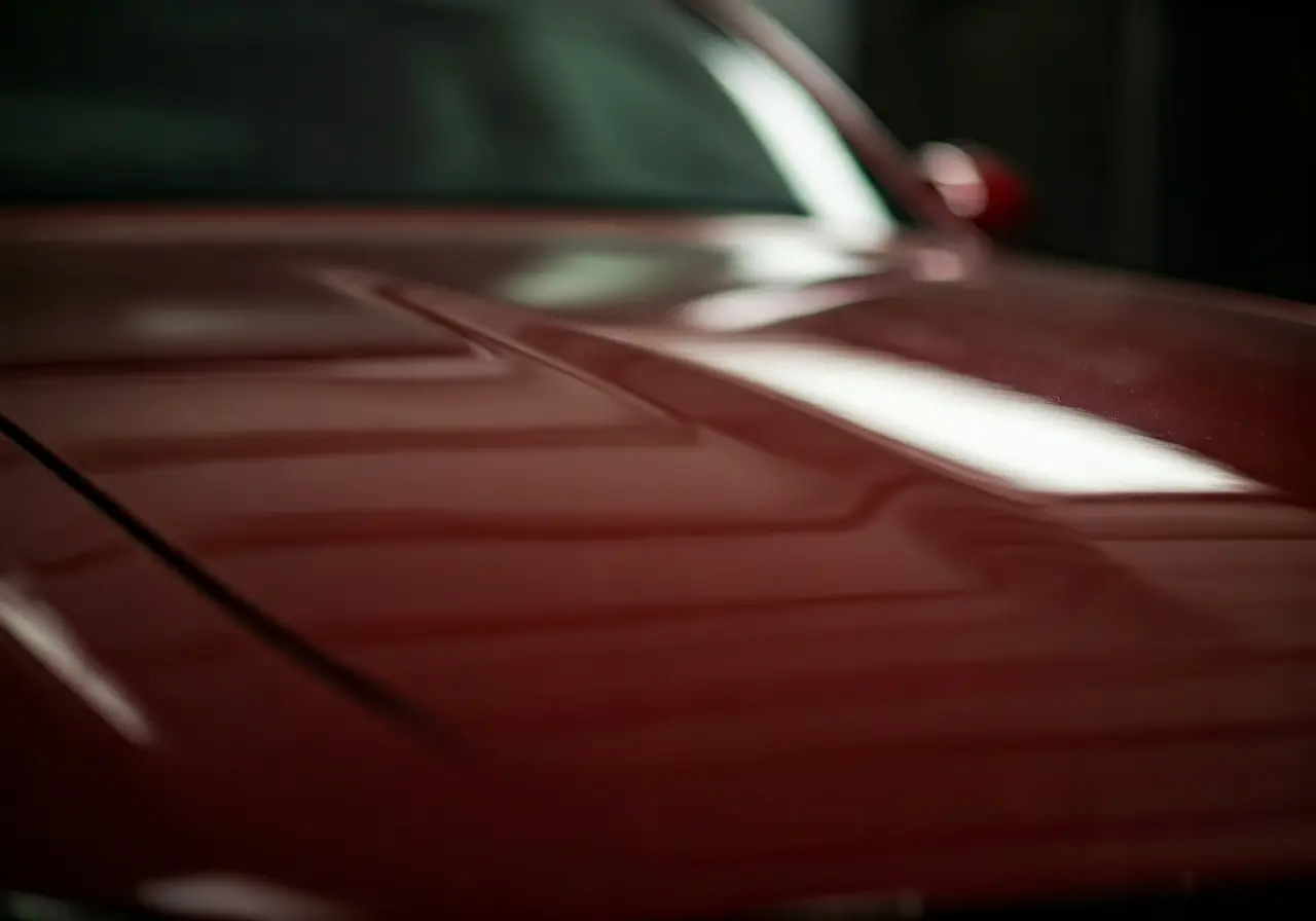 A close-up of a shining, freshly coated car surface. 35mm stock photo